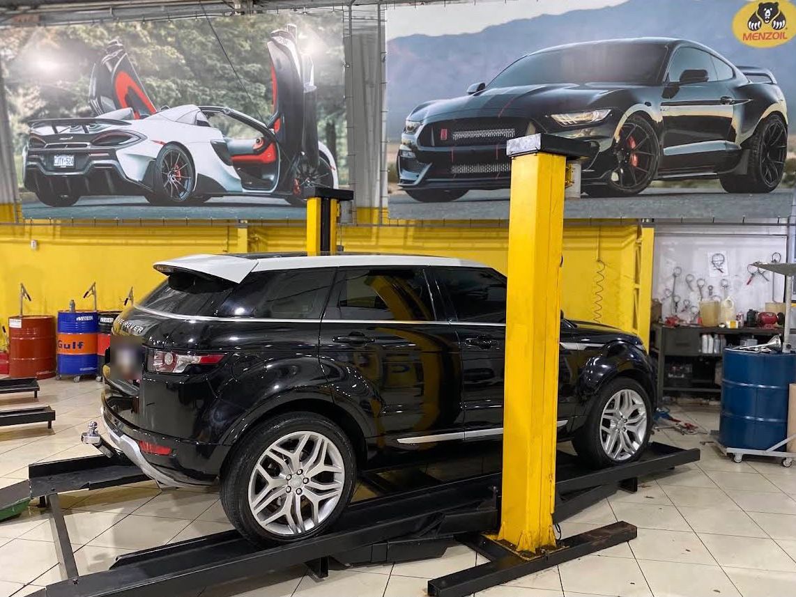 Range Rover suspenso no elevador durante a manutenção
